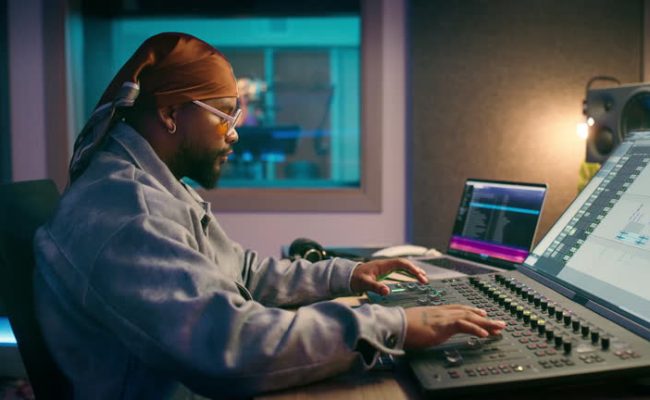 Music studio, producer and man with equipment, listen and talent with tech, artist and equalizer. Skills, person and sound engineer with audio mixer, artist and creative with frequency mode and dj